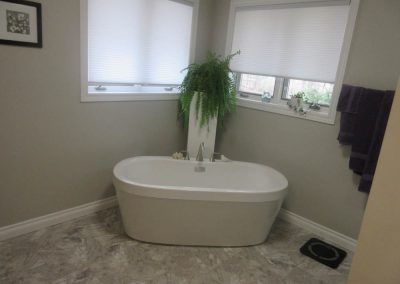 Large White Bath Tub with Silver Accents