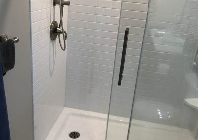 White Shower Tiles with Glass Doors