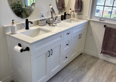 Custom Bathroom renovations with dual sinks in a white and cream bathroom.