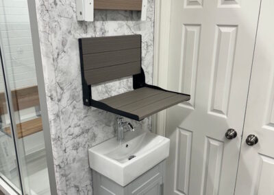 In the showroom, there is an example of the shower seats that can be mounted inside of a bathroom for safety and accessibility.