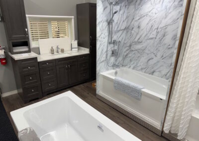 A custom vanity, along with bath tubs and showers being shown available as options in the show room.