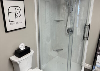 A custom round cornered shower with clear glass doors.