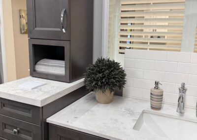 A closer view of the counter, sink, and cupboards of the custom vanity that is available for viewing in the Show Room